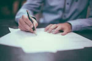 Signing an official letter with a pen