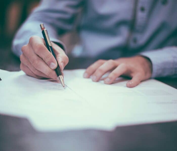 Signing an official letter with a pen